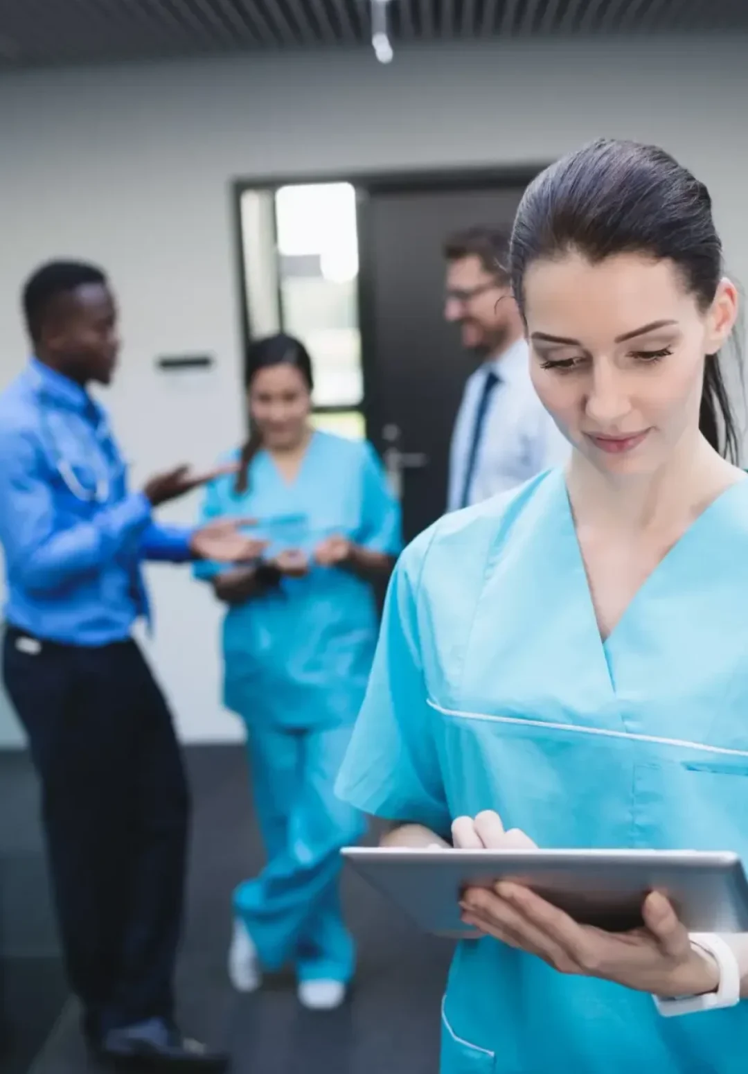 nurse-using-digital-tablet-hospital-corridor-scaled-r1s3srfd4a2k5uqhxkvleyc9czxqqtd7p24enukcng